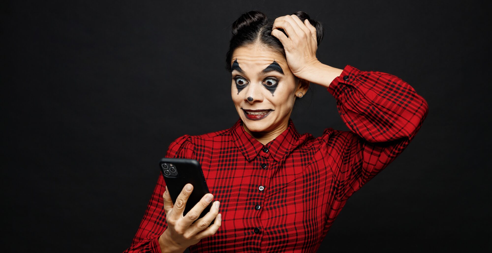 clown looking surprised at her phone